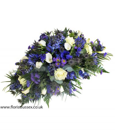 Shades of Blue - A striking assortment of blue and white, including delphinium, agapanthus, thistle, calla lilies, roses and more.