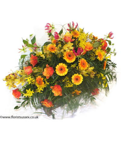 Wild Autumn - A burst of brilliant orange and yellow shades in a wild, grassy display. Including gerberas, roses, forsythia, gloriosa and orchid amongst lush foliage. 
Please note that some flower types are not available all year round and may need to be substituted for a similar flower if not in season.