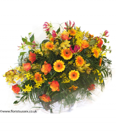 Wild Autumn - A burst of brilliant orange and yellow shades in a wild, grassy display. Including gerberas, roses, forsythia, gloriosa and orchid amongst lush foliage. 
Please note that some flower types are not available all year round and may need to be substituted for a similar flower if not in season.