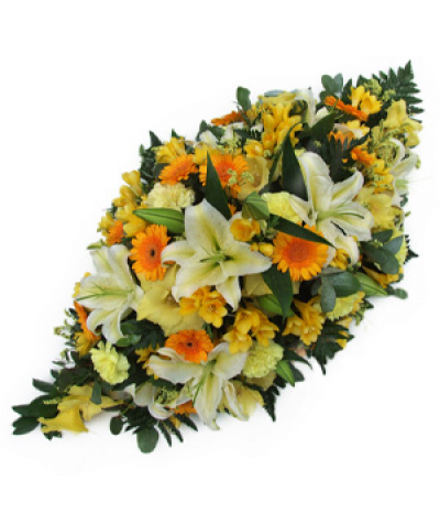 Golden Moments - Golds, yellows and creams in a traditional spray design for a gorgeous tribute to someone special- featuring lilies, gerberas, freesias and more.