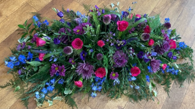 Purple Haze - Gorgeous vibrant hues of purple, blue and pink accented with loose grasses and flowing ferns create a rustic, summery display.
Please note that flower varieties are subject to seasonal availability and will otherwise be substituted for similar flowers.