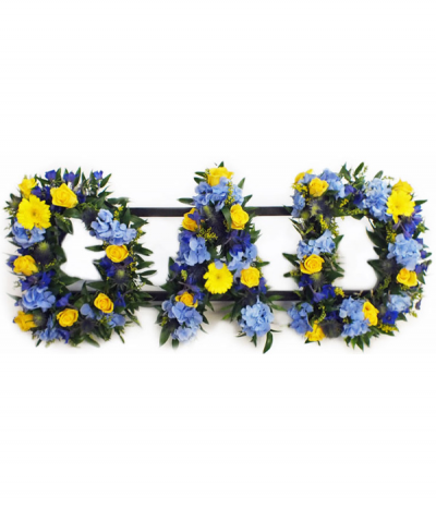 DAD 05 - Loose lettering, meaning that the letters are filled with greenery and mixed flowers in a more natural style. This example includes bold yellow and blue seasonal flowers. Any wording can be created in this style, and colours can be altered to suit your preferences- please call to discuss.