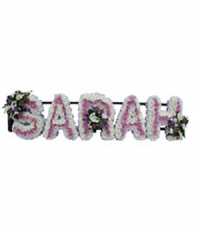Five-letter name tribute (Sarah) - Example lettering "Sarah" massed in white and soft pink chrysanthemums, finished with pretty pink and white flower sprays. Any wording can be created in this style, and colours can be altered to suit your preferences- please call us to discuss your requirements or note your five-letter name in the "any special requests" box to order online.