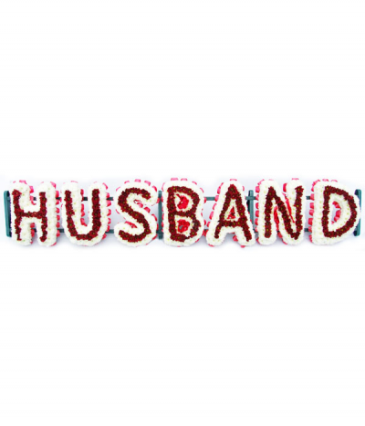 Husband - Lettering "Husband" massed in striking white and red chrysanthemums. The letters are framed with red pleated ribbon edging. Any wording can be created in this style, and colours can be altered to suit your preferences- please call us to discuss.