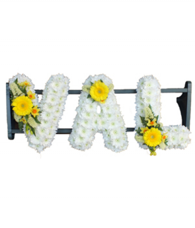 Three-letter name tribute (Val) - Example lettering "Val" massed in white chrysanthemums, finished with yellow flower sprays. Any wording can be created in this style, and colours can be altered to suit your preferences- please call us to discuss your requirements or note your three-letter name in the "any special requests" box to order online.
£45.00 per letter.