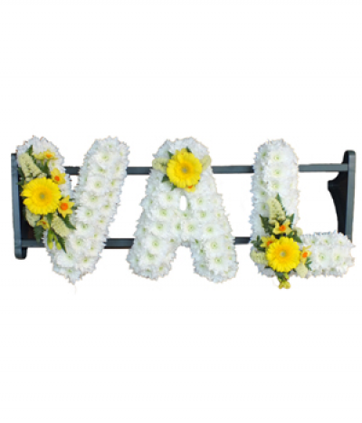 Three-letter name tribute (Val) - Example lettering "Val" massed in white chrysanthemums, finished with yellow flower sprays. Any wording can be created in this style, and colours can be altered to suit your preferences- please call us to discuss your requirements or note your three-letter name in the "any special requests" box to order online.
£45.00 per letter.