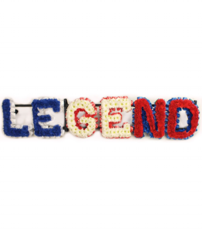 Legend - Striking "Legend" lettering in blue-dyed, natural white and red-dyed massed chrysanthemums with matching pleated ribbon edging to compliment. 
Any wording can be created in this style, and colours can be altered to suit your preferences- please call us to discuss.
£45.00 per letter.