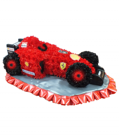 Formula One Car - A 3D formula one car design, expertly crafted from massed dyed chrysanthemums and finished with racing decals. Stood on a silver base with red pleated ribbon edging.