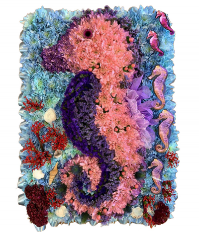 Seahorse Tribute - A beautiful floral seahorse design created using pink and purple dyed chrysanthemums, on a blue background