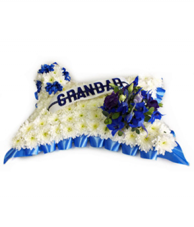 Blue and White Football Pillow - A massed white chrysanthemum pillow design finished with royal blue ribbon edging, a spray of blue flowers and a mini football in each corner, and any name or word on a ribbon