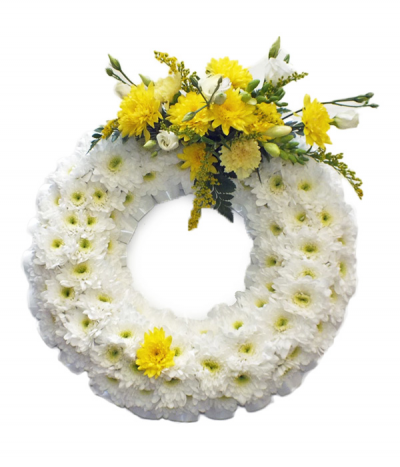 Saffron Wreath - A classic massed wreath design, using white chrysanthemums as a base and finished with a bright yellow spray of seasonal flowers.