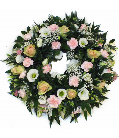Bella Wreath - A natural wreath tribute featuring lots of luscious foliage and including beautiful dusky pink roses, white lisianthus, gypsophila and baby pink carnations.