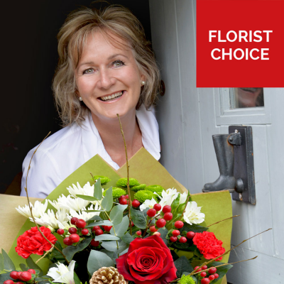 Christmas Florist Choice Hand-Tied - A festive hand-tied filled with the seasonal flowers, perfectly wrapped by the local florist and delivered in water.
