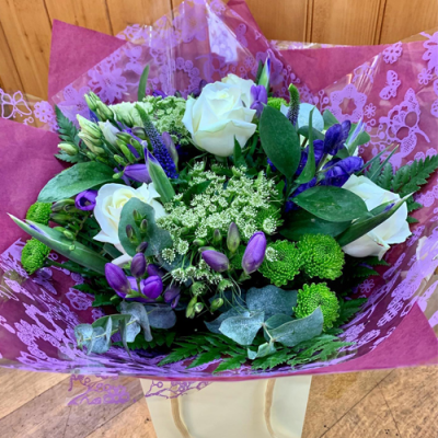 Sugar Plum - A beautiful handtied bouquet in water presented in a gif bag/box. Created using purple and white flowers with complimentary foliage.