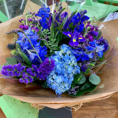 Sea Mist - A beautiful bouquet in water presented in a gift bag/box. Created using all blue and purple seasonal flowers with complimentary foliage.